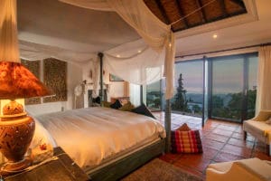 Photo of a bedroom with a four-poster bed in Mijas by Jason Elliott